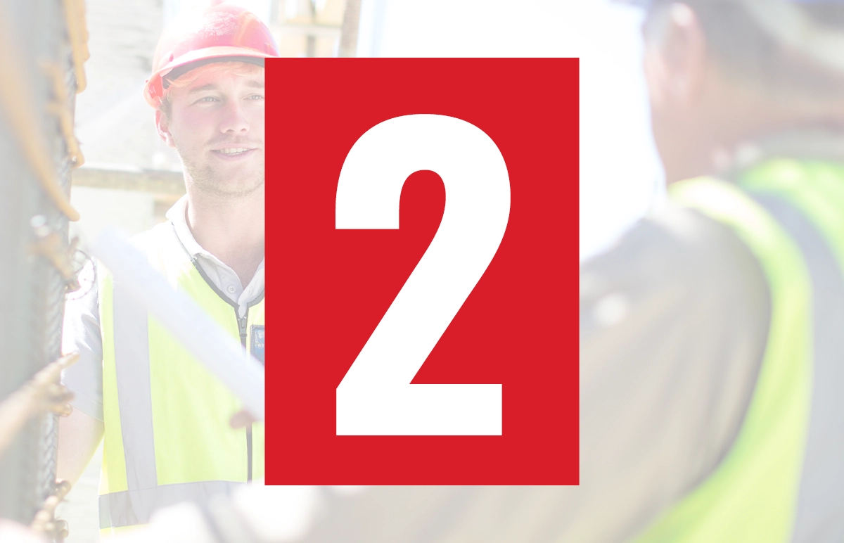 Technicians in safety gear gathered on an industrial worksite