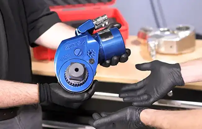 A HYTORC hydraulic torque wrench being handed over during a tool trade-in
